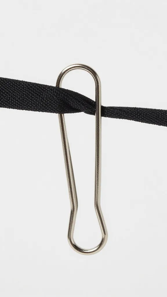 stainless clip resisting gust, fabric tension visible