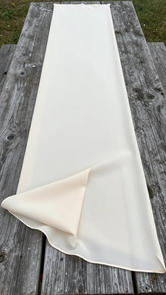 draped ivory chiffon runner on weathered picnic table plank
