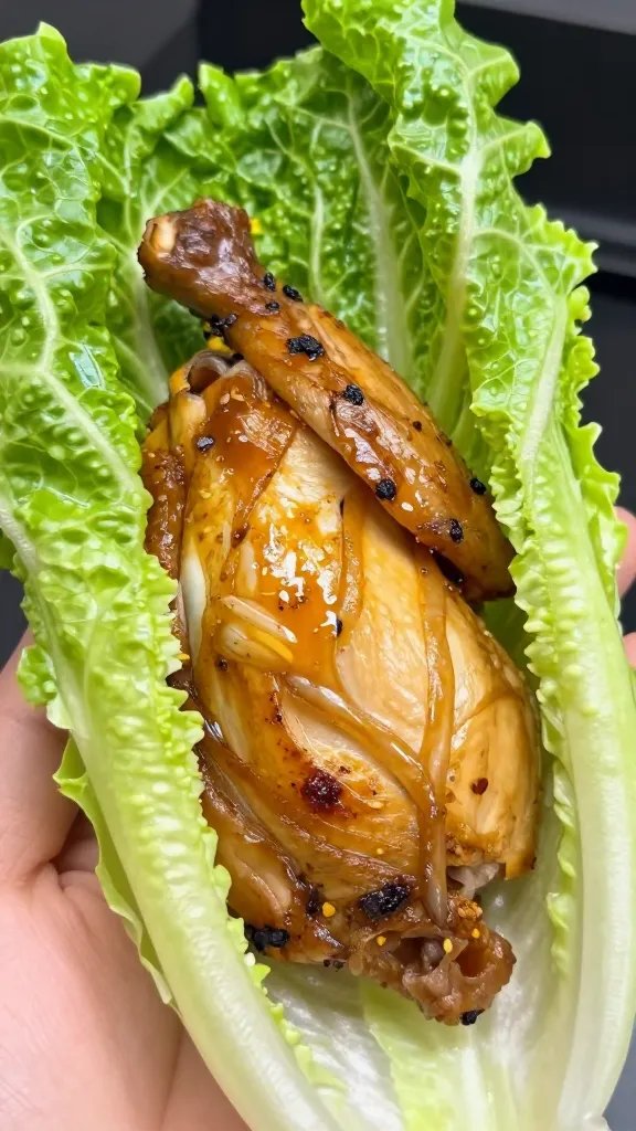 single romaine leaf filled with rotisserie chicken, closeup