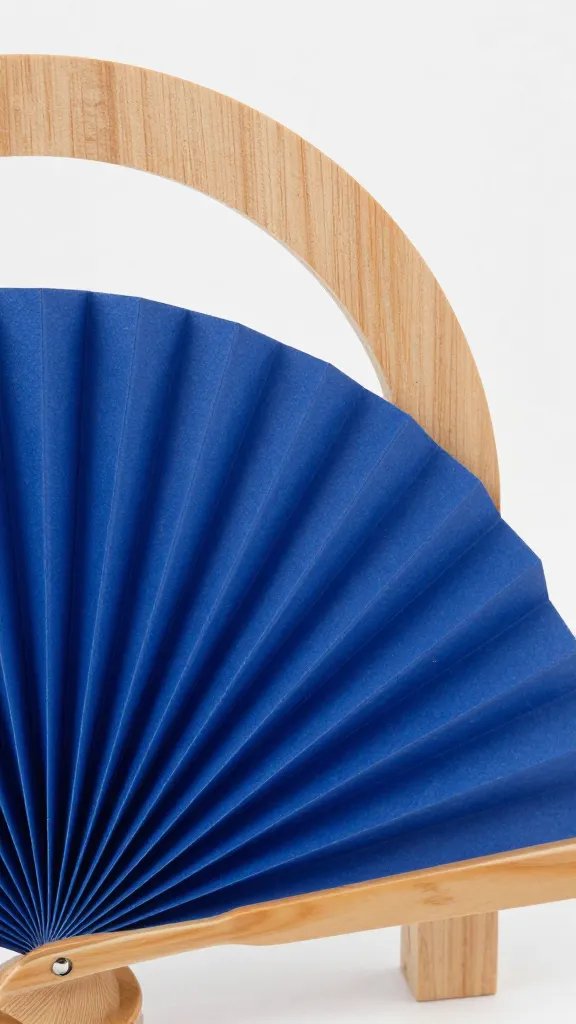 single cobalt-blue paper fan against plywood arch, closeup