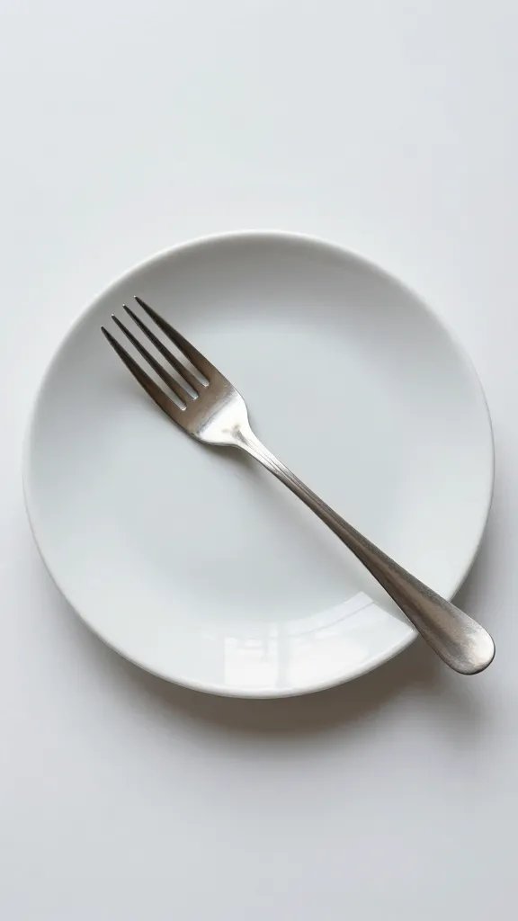 single empty dessert plate with fork, soft light