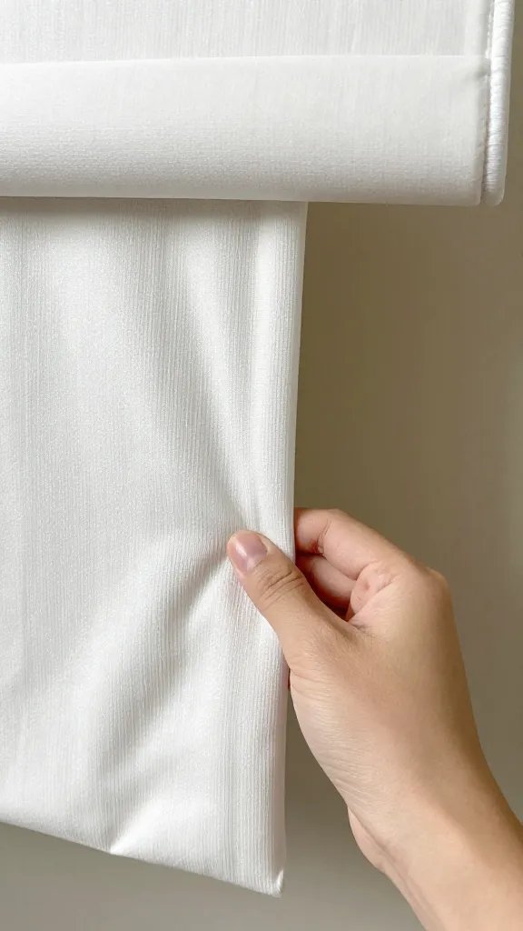 hand placing blanket edge parallel to shade