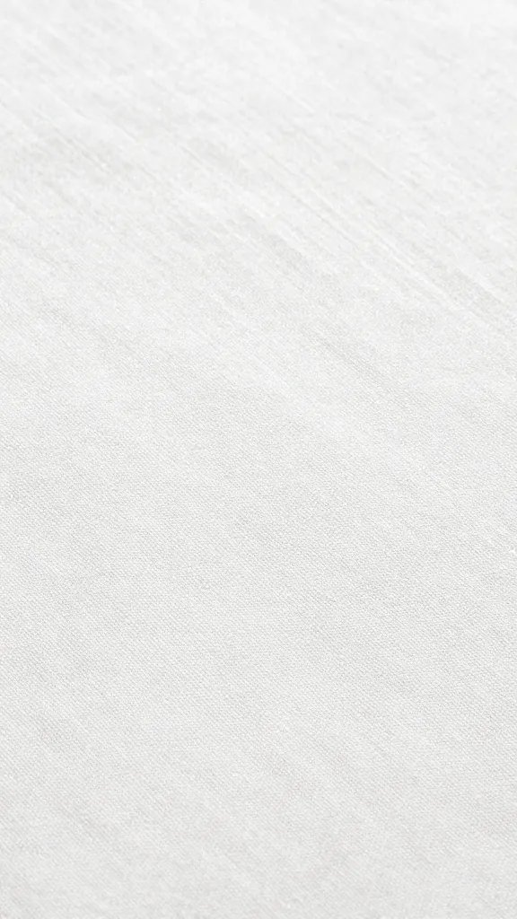 closeup of thin cotton tablecloth revealing tabletop grain beneath