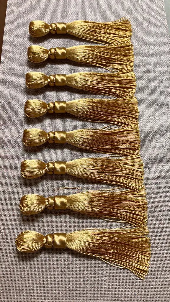 trimmed tassel ends aligned crisply on craft mat