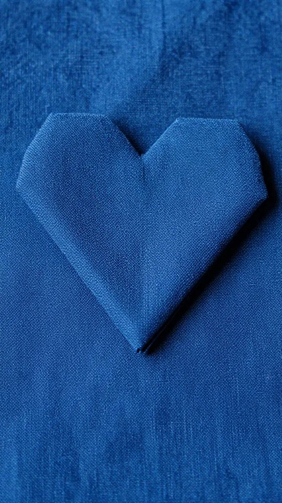 indigo napkin heart fold, tight macro on pointed tip