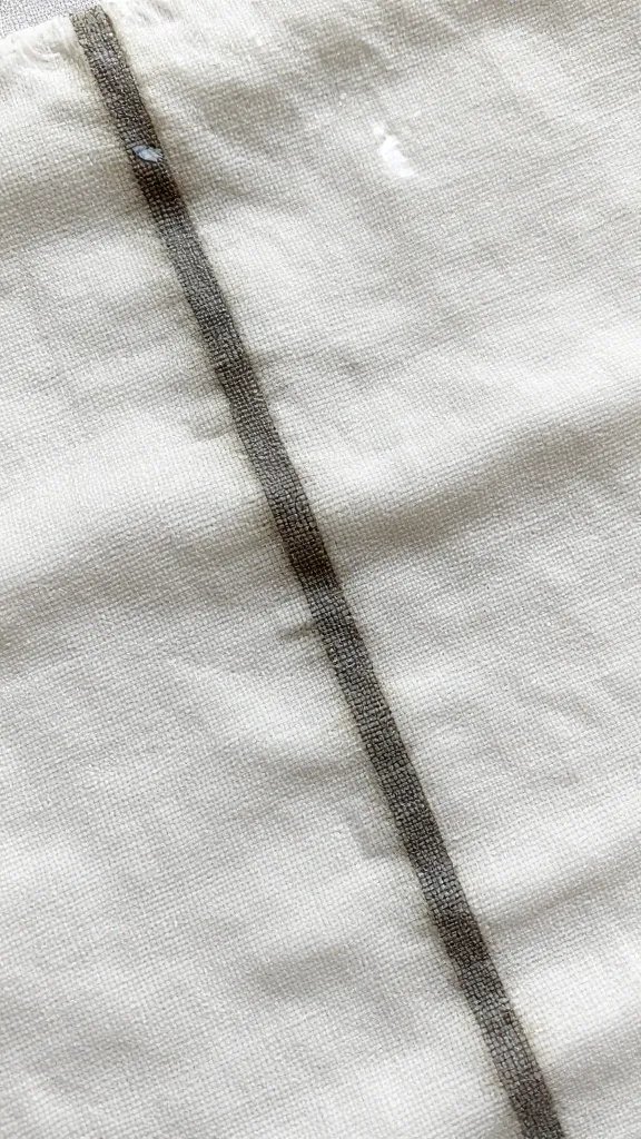macro shot of wet linen napkin showing darkened soak line