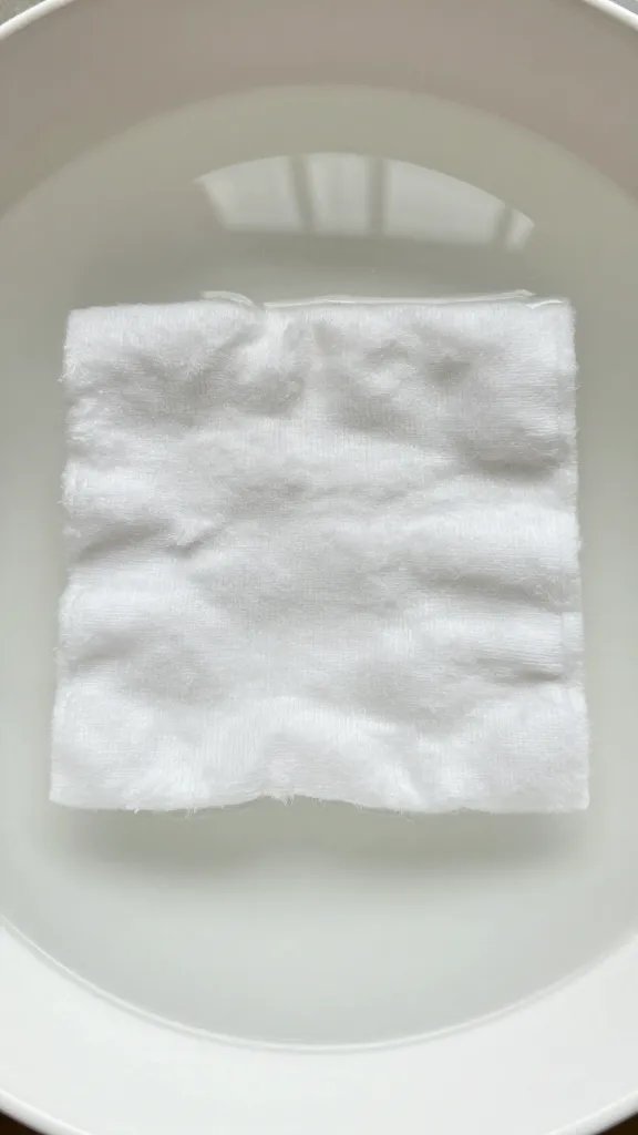 white cotton swatch in lukewarm soak bowl, top-down
