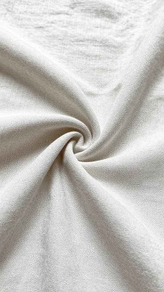 closeup crease detail of butterfly-fold in wrinkled linen