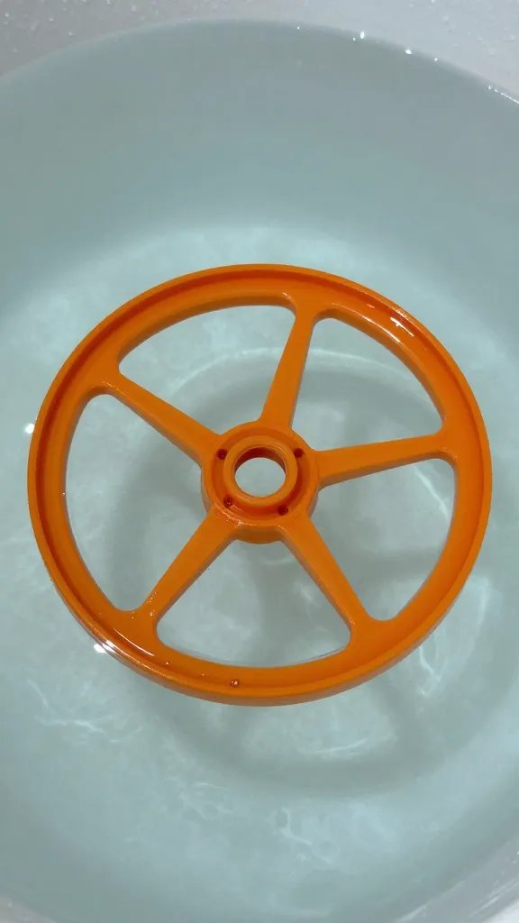 thin orange wheel submerged in crystal water, macro