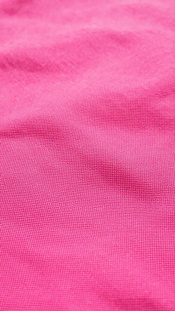 Closeup of hot pink picnic blanket texture in sunlight