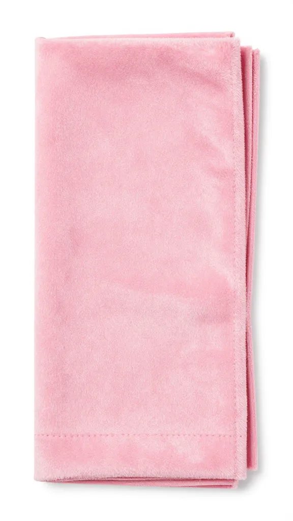 Closeup of soft pink velvet napkin folded elegantly