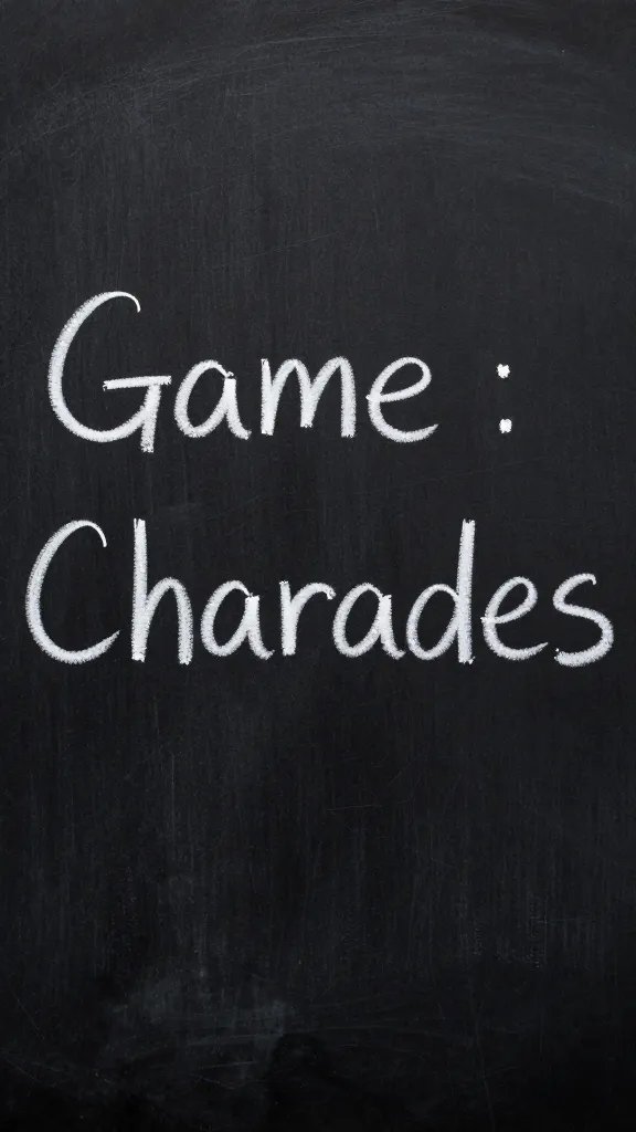 Closeup of a single chalkboard sign showing “Game: Charades”