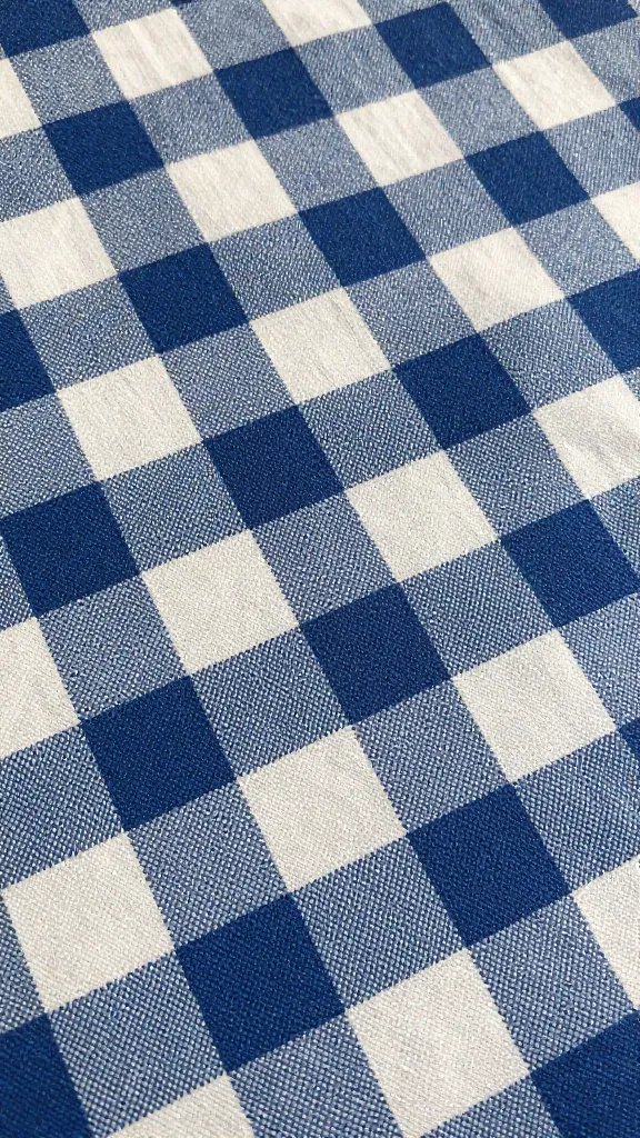 closeup of fabric weave catching afternoon light on picnic backdrop