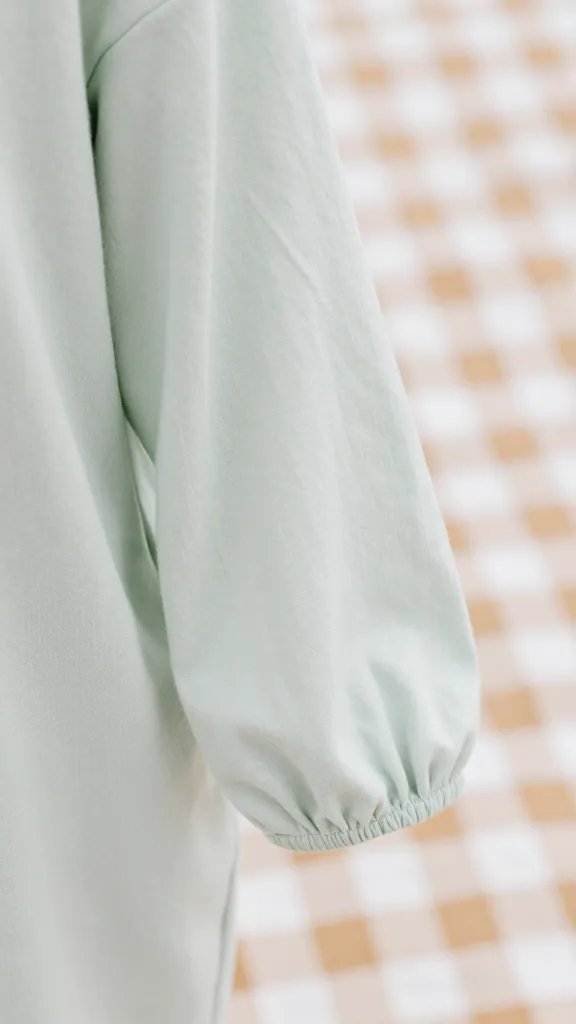 closeup of maternity gown sleeve draped over picnic blanket