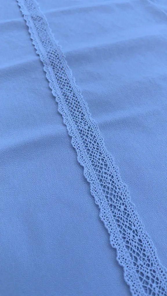 closeup of a single lace-edged picnic cloth under twilight