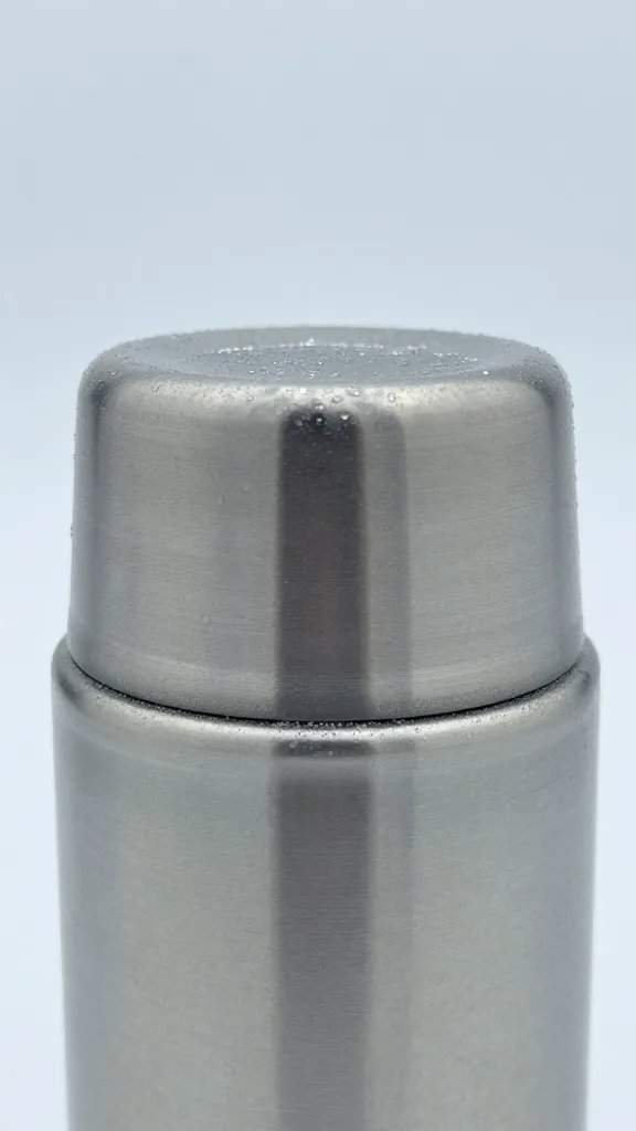closeup of a thermos cap with frost on glass