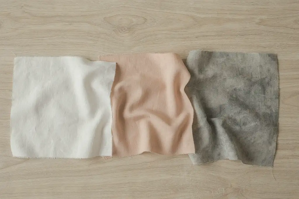 Comparison of linen, cotton, and stonewashed fabric swatches for napkin folding