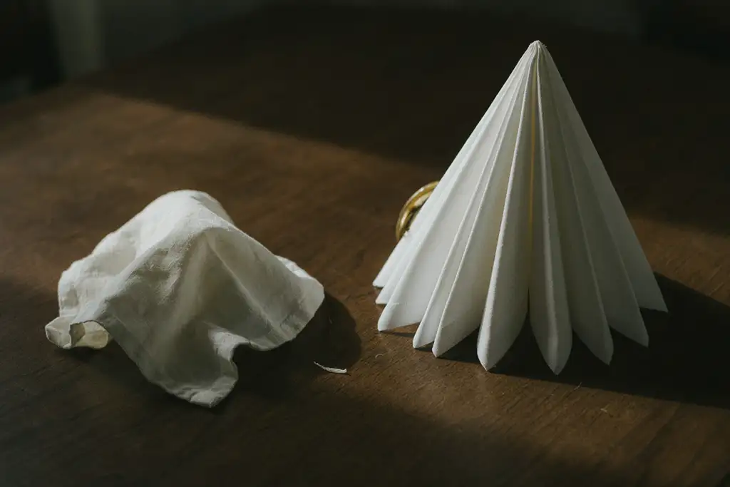 Side by side comparison of poorly folded vs well-folded napkins